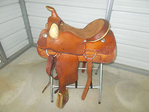 16" Billy Cook roping saddle with some rawhide and tooling around it