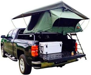 camping tent sets up on top of truck keep you of the ground and bugs .