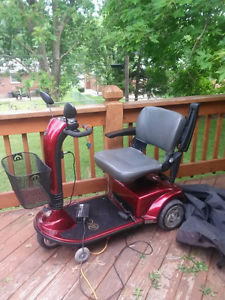 Red mobile scooter in good condition also comes with a charger, basket, cover