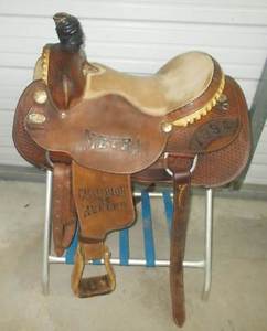 Older 15" Running P Trophy roping saddle with rawhide and little bit of tooling
