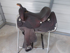 15" Circle Y trail saddle with leather seat and tooled leather with some silver